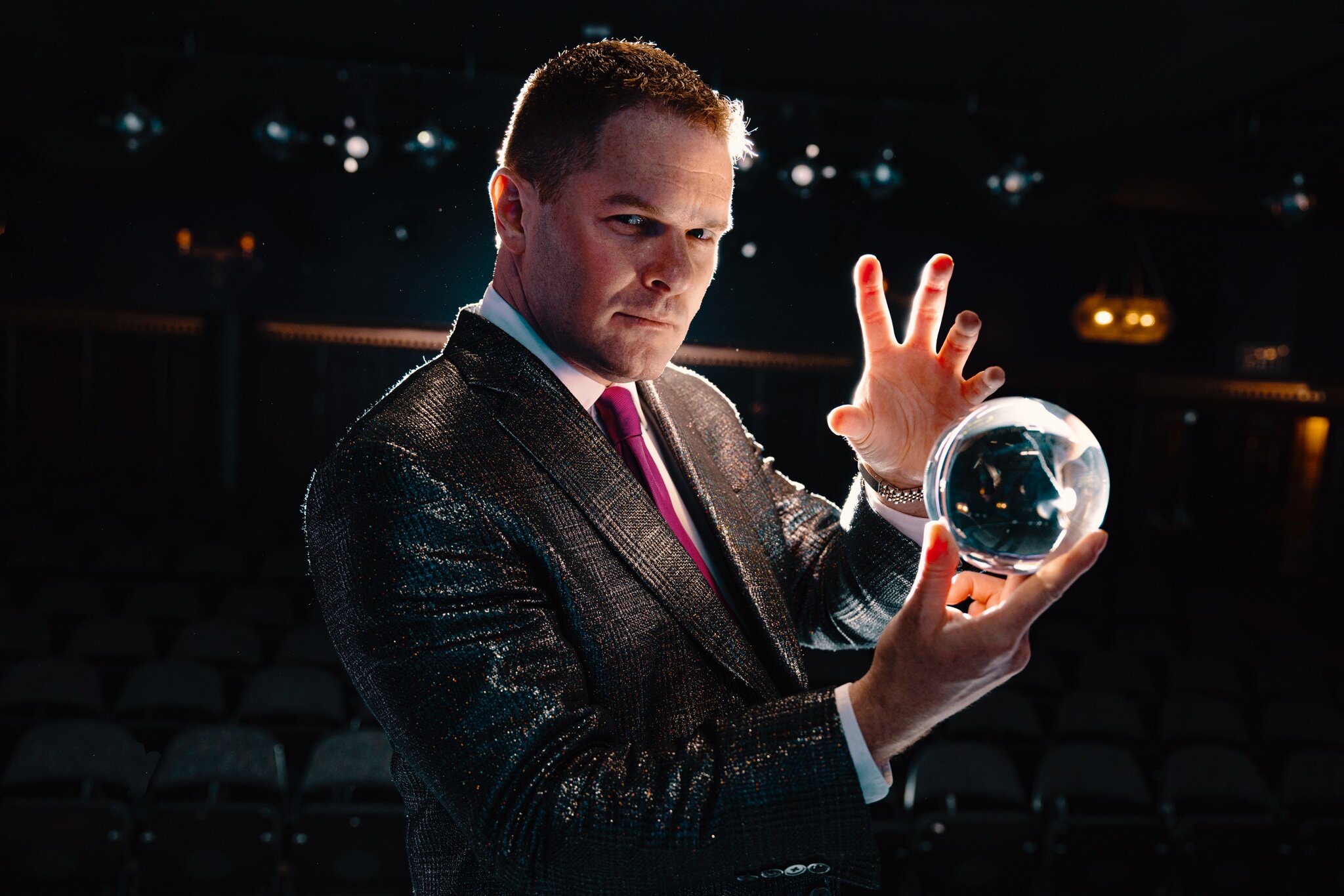 A promotional photo of Mentalist Michael Gutenplan holding a crystal ball.