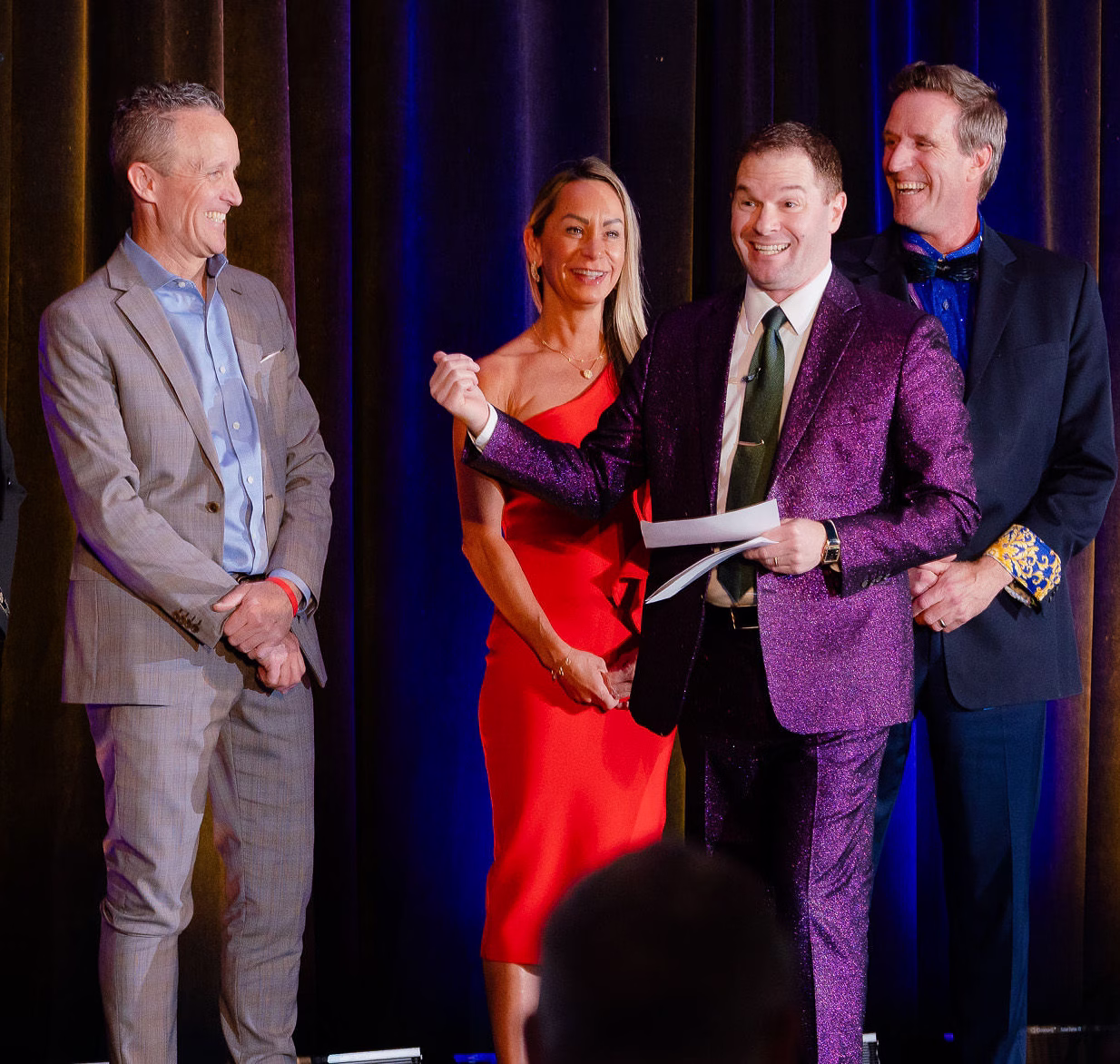 Mentalist Michael Gutenplan performing on stage with three volunteers at a corporate event.