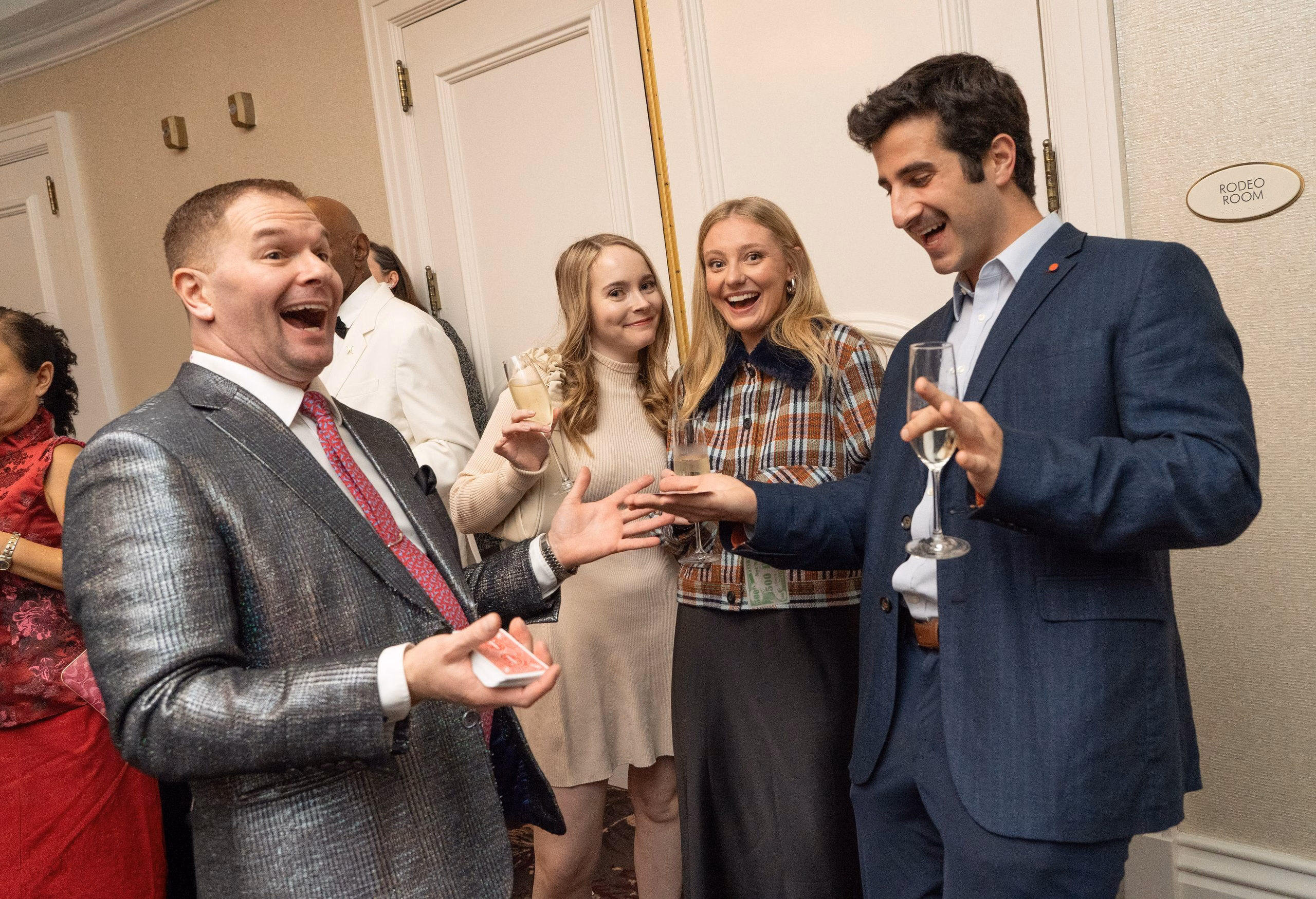 Magician Michael Gutenplan performing strolling magic at a corporate holiday party.